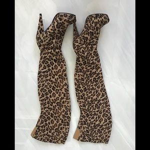 Thigh high platform leopard print boots.